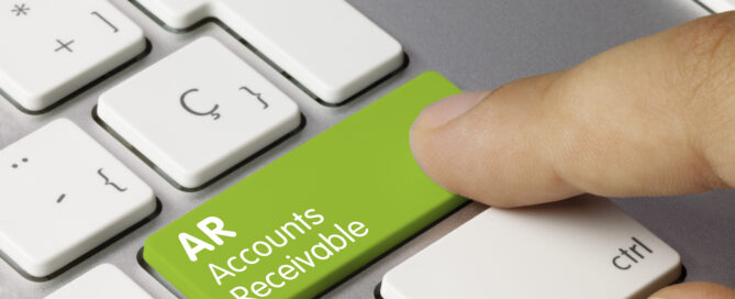 AR Accounts Receivable analysis- Inscription on Green Keyboard Key. AR Accounts Receivable Written on Green Key of Metallic Keyboard. Finger pressing key